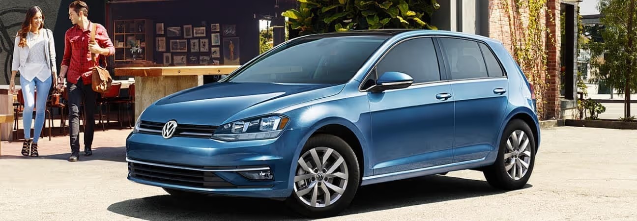 a couple walking towards their 2019 Volkswagen Gold in blue