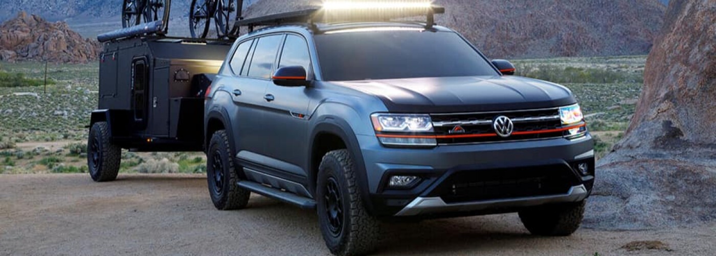 a blue Tiguan pulling a trailer