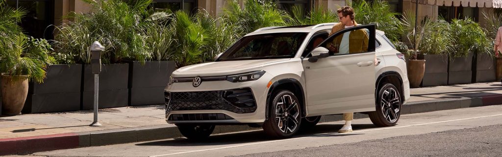 Volkswagen Tiguan parked on a city street with a person stepping out