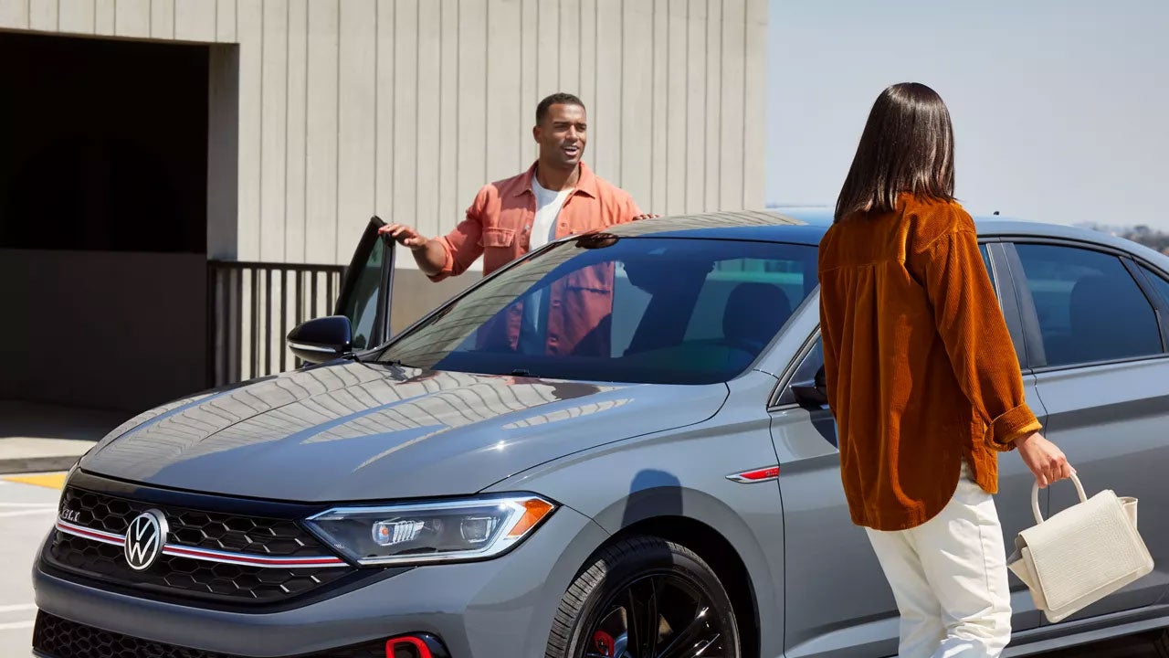 Couple near their Volkswagen vehicle - Street Volkswagen of Amarillo in Amarillo TX